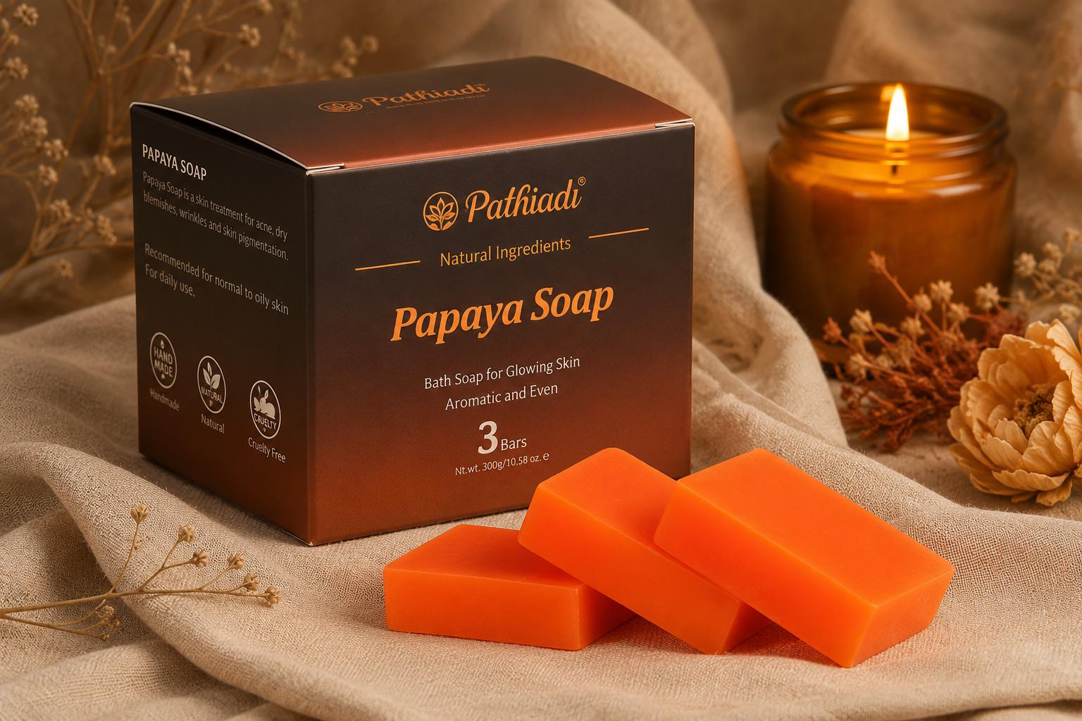 Premium vegan skincare gift set featuring elegant brown packaging and natural orange papaya soap bars arranged beautifully with a glowing candle.